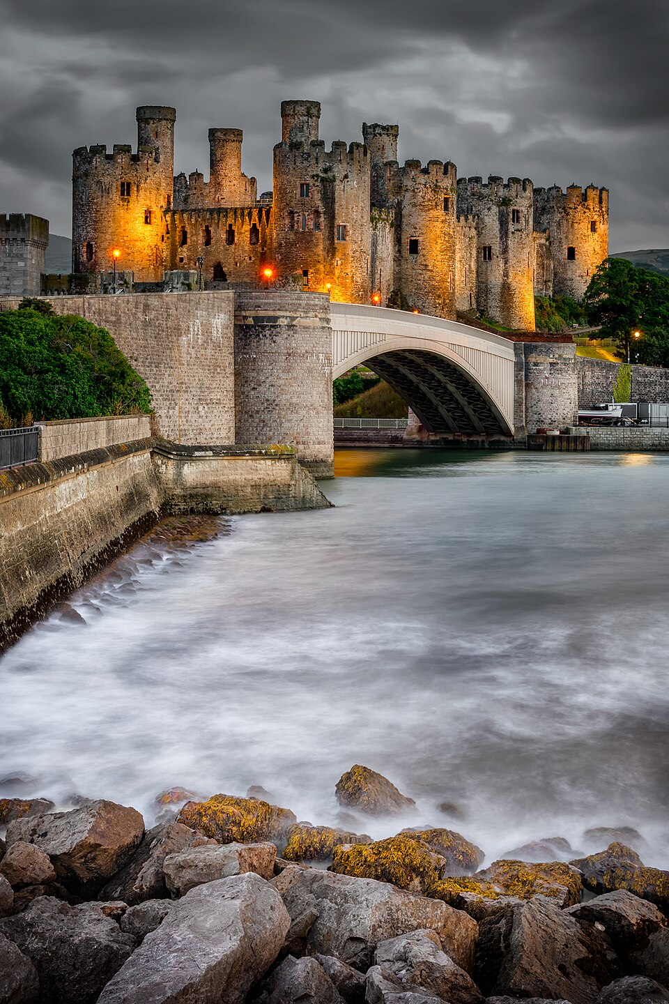 Conwy Castle illuminated at night, reflecting the dark grandeur of Westeros