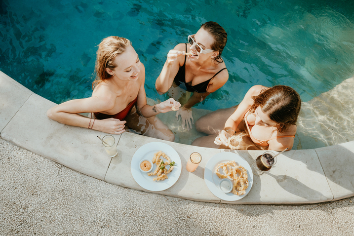 Resort pool area surrounded by tropical gardens where reality TV drama unfolds
