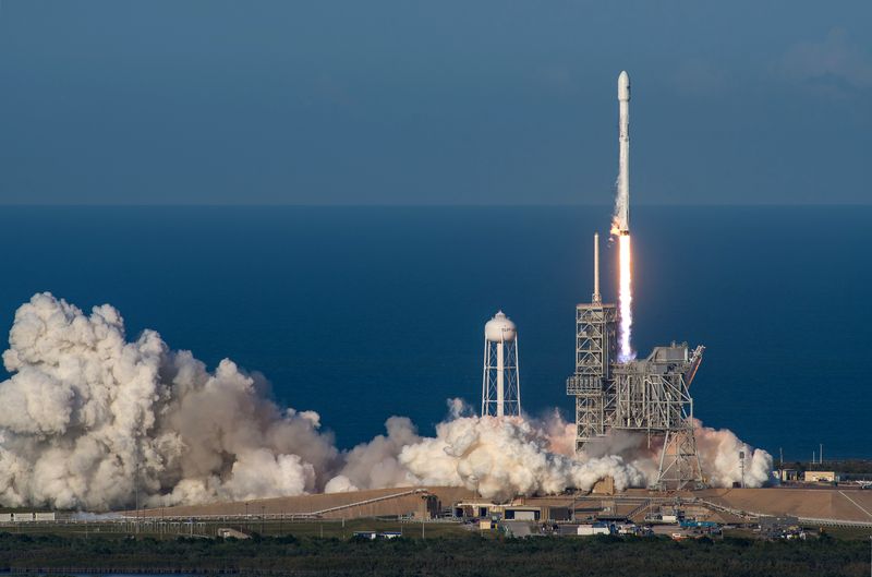 SpaceX Falcon 9 rocket launching into twilight sky