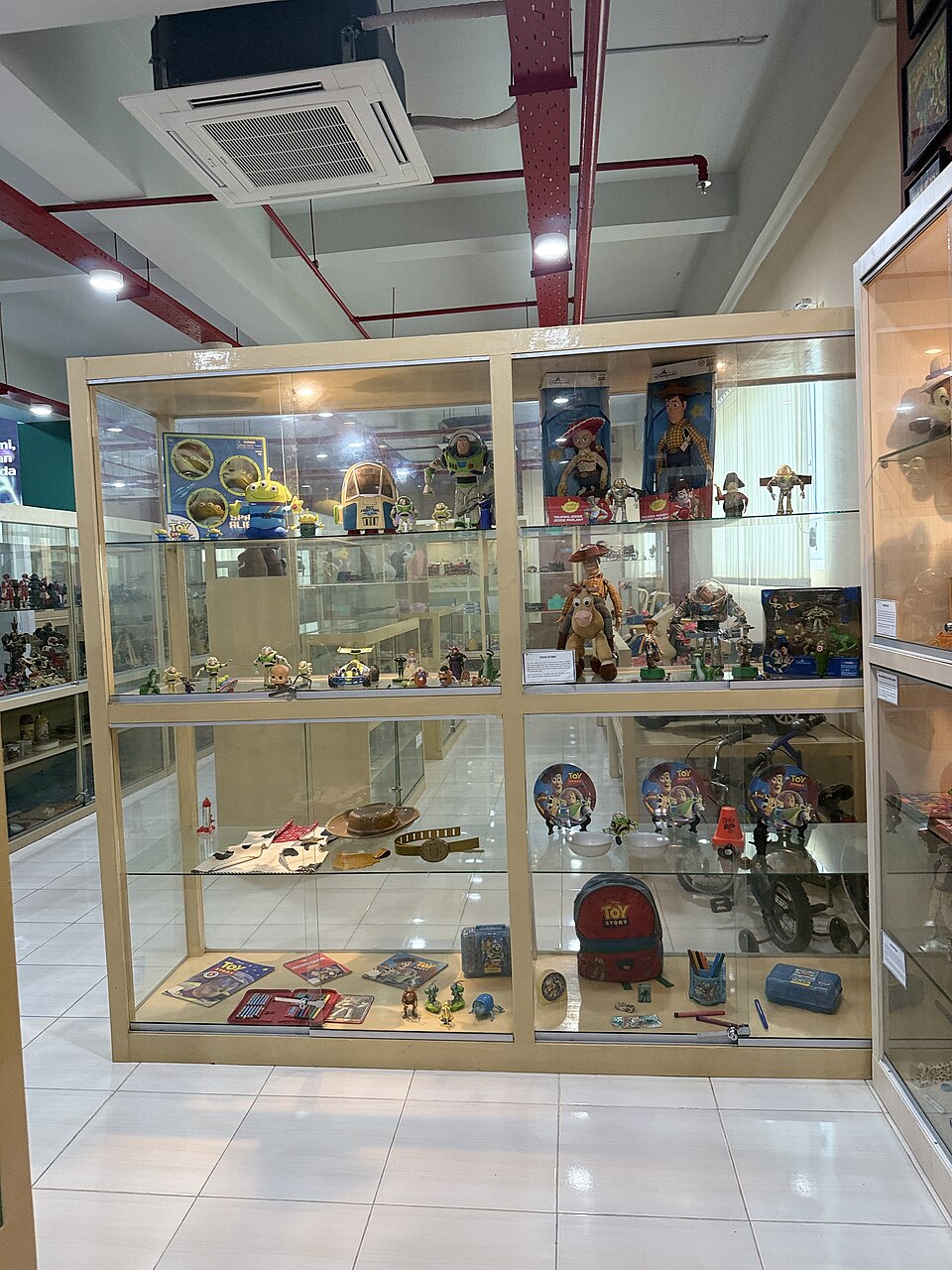 Toy Story character collection display at museum featuring Buzz Lightyear and friends